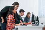 Am I doing it right. Group of young people in casual clothes working in the modern office