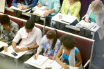 group of students with notebooks at lecture hall