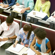 group of students with notebooks at lecture hall