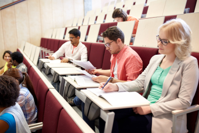 group of students writing test at lecture hall