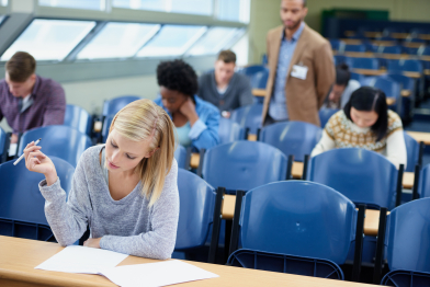 exam-classroom-student-with-pen-thinking-assessment-writing-campus-woman-planning-sitting-with-paper-brainstorming-education-growth-knowledge-university-class