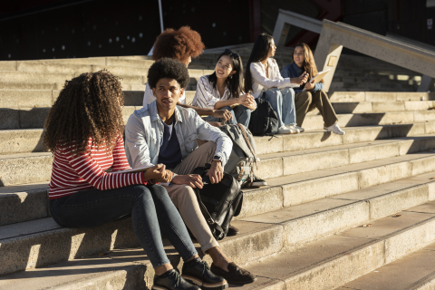 group of happy teen high school students outdoors