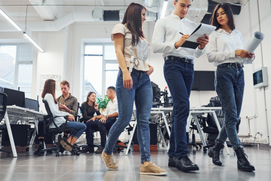 Group of young employees talking and working at new project in the office