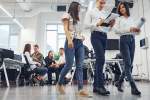 Group of young employees talking and working at new project in the office