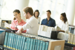 people-standing-by-bookshelves-library