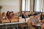 Students sitting at their desks attending to the explanation of the university professor. Concept: education, learning, studies