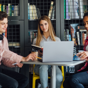 three-happy-students-writing-notebooks-laptop-library (1)