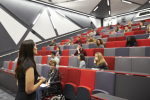 Woman lecturing students in a university lecture theatre